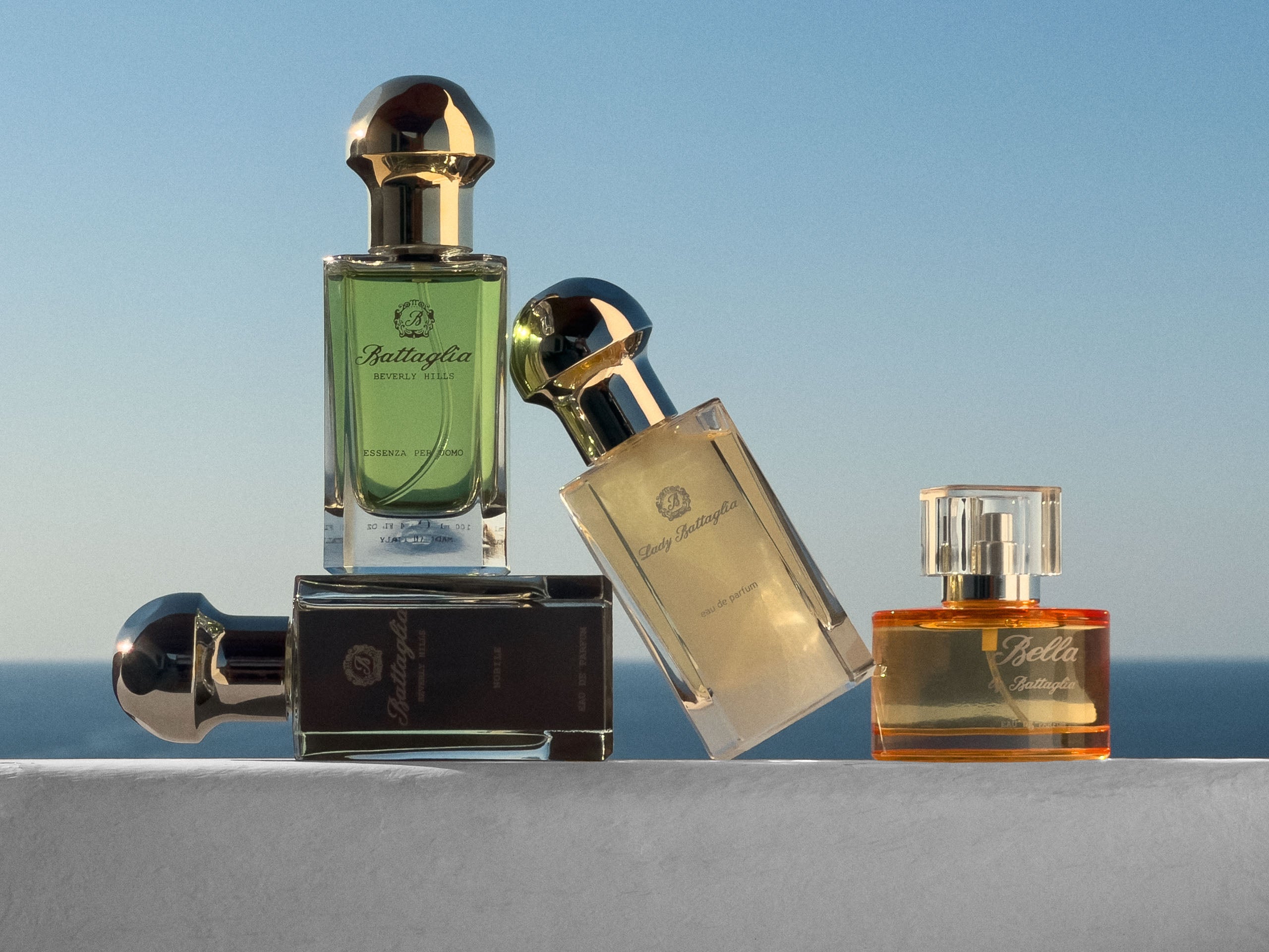 Collection of perfume bottles with a sea side background