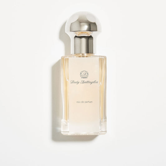 A photo of the Lady Battaglia fragrance by Battaglia. The bottle is clear and rectangular with a silver circular top against a white background. 
