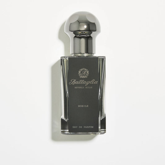 A photo of the Nobile fragrance by Battaglia against a white background.  The bottle is rectangular and black with a grey circular top. 