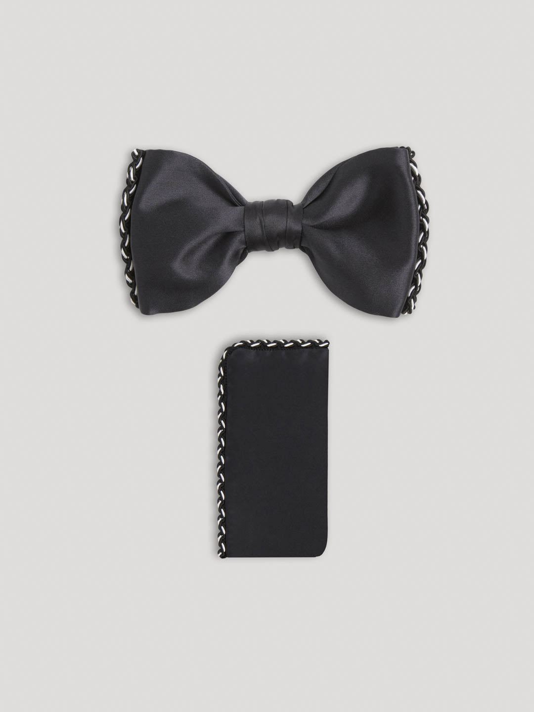 Black silk bow ties with woven side details and matching handkerchief.
