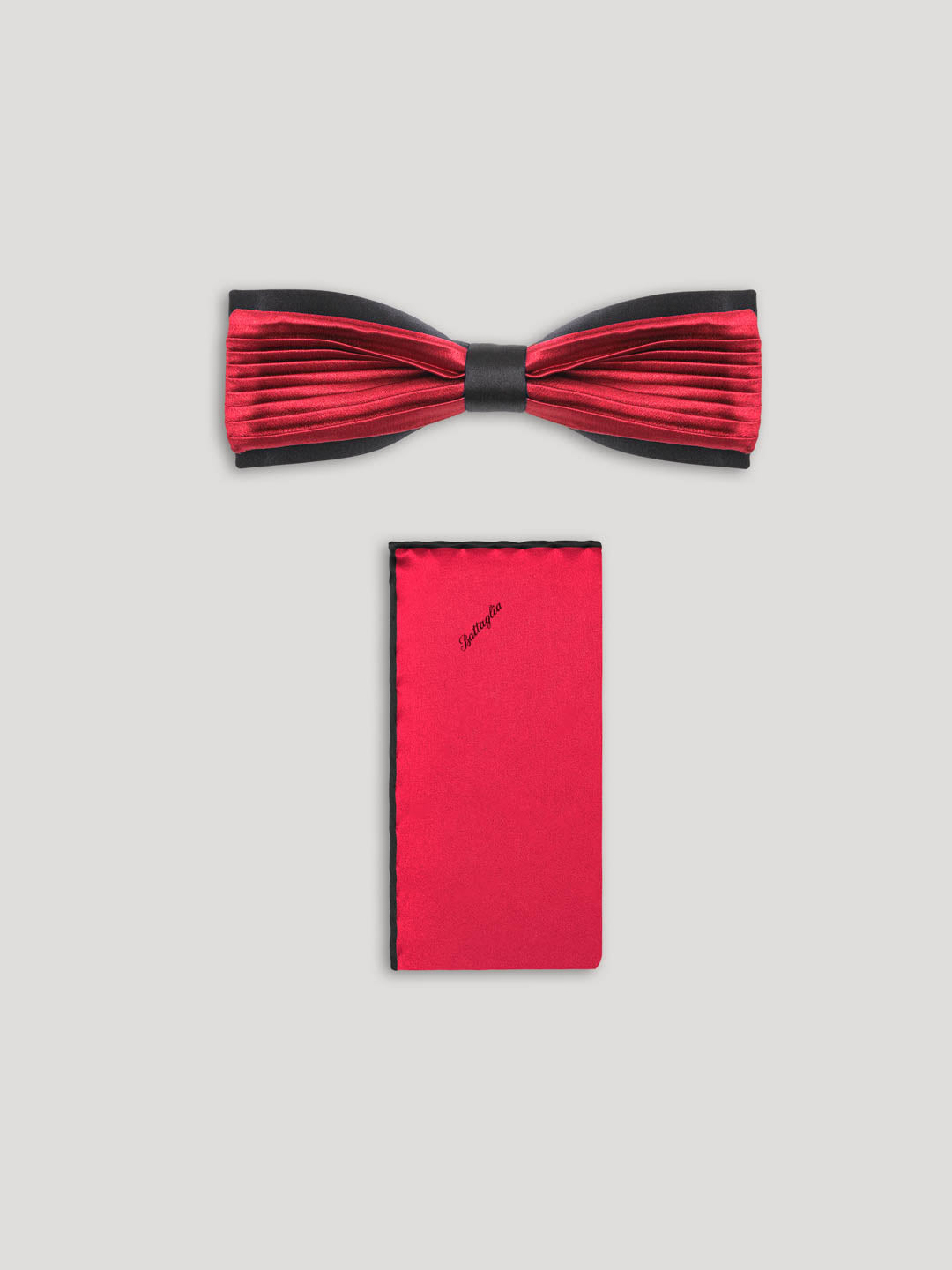 Red pleated bowtie with matching handkerchief.