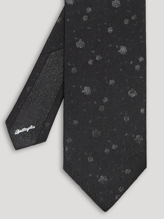 Black silk tie with silver floral details.