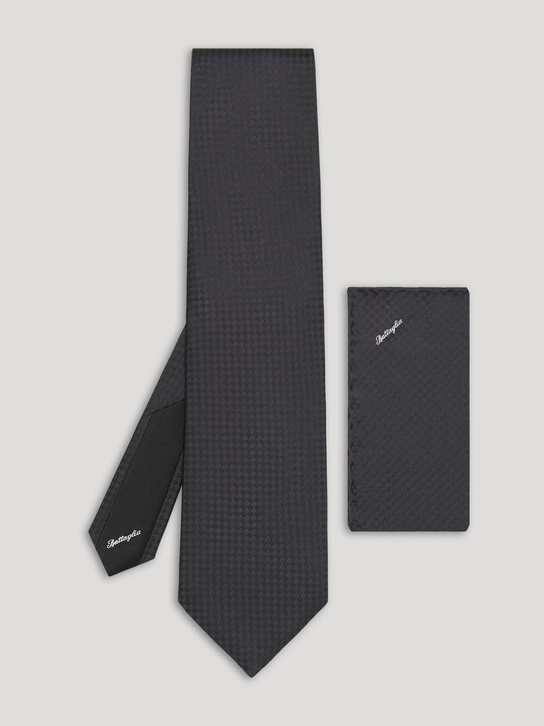Black tone on tone check pattern silk tie with matching handkerchief.