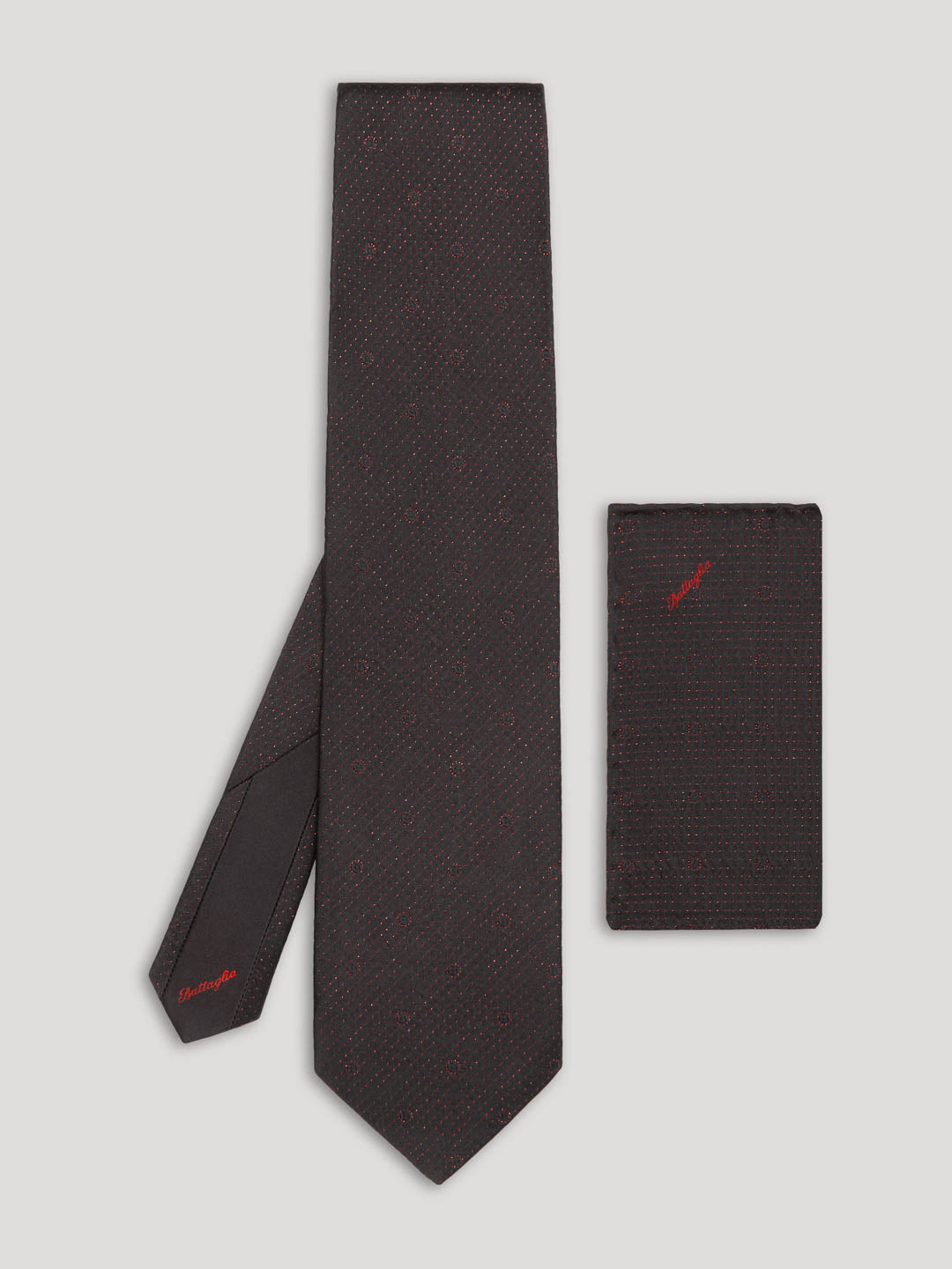Black tie with red polkadots and matching handkerchief.
