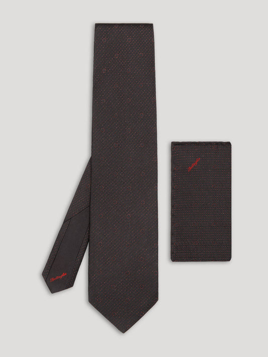 Black tie with red polkadots and matching handkerchief.