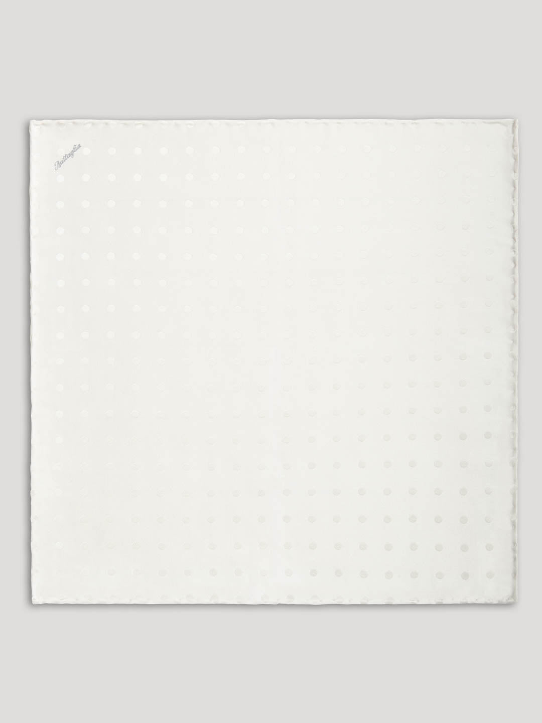 White silk handkerchief with polkadots.
