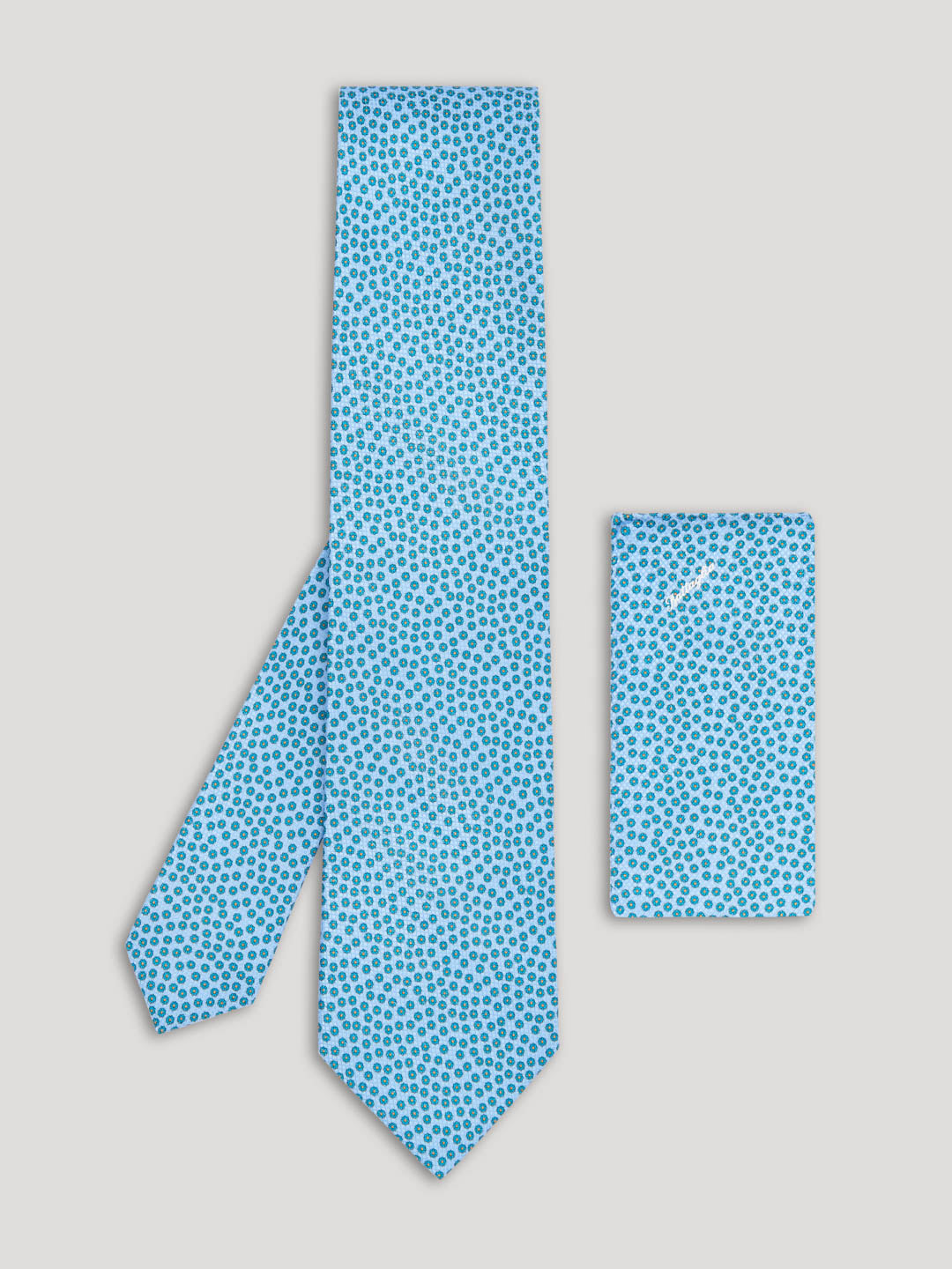 Light blue floral pattern tie with matching handkerchief.