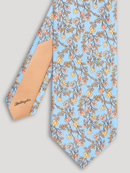 Light blue tie with yellow and orange floral details. 