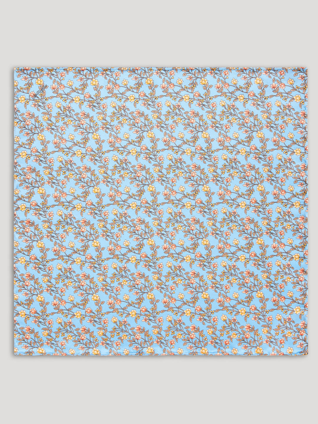 Light blue handkerchief with yellow and orange floral details.