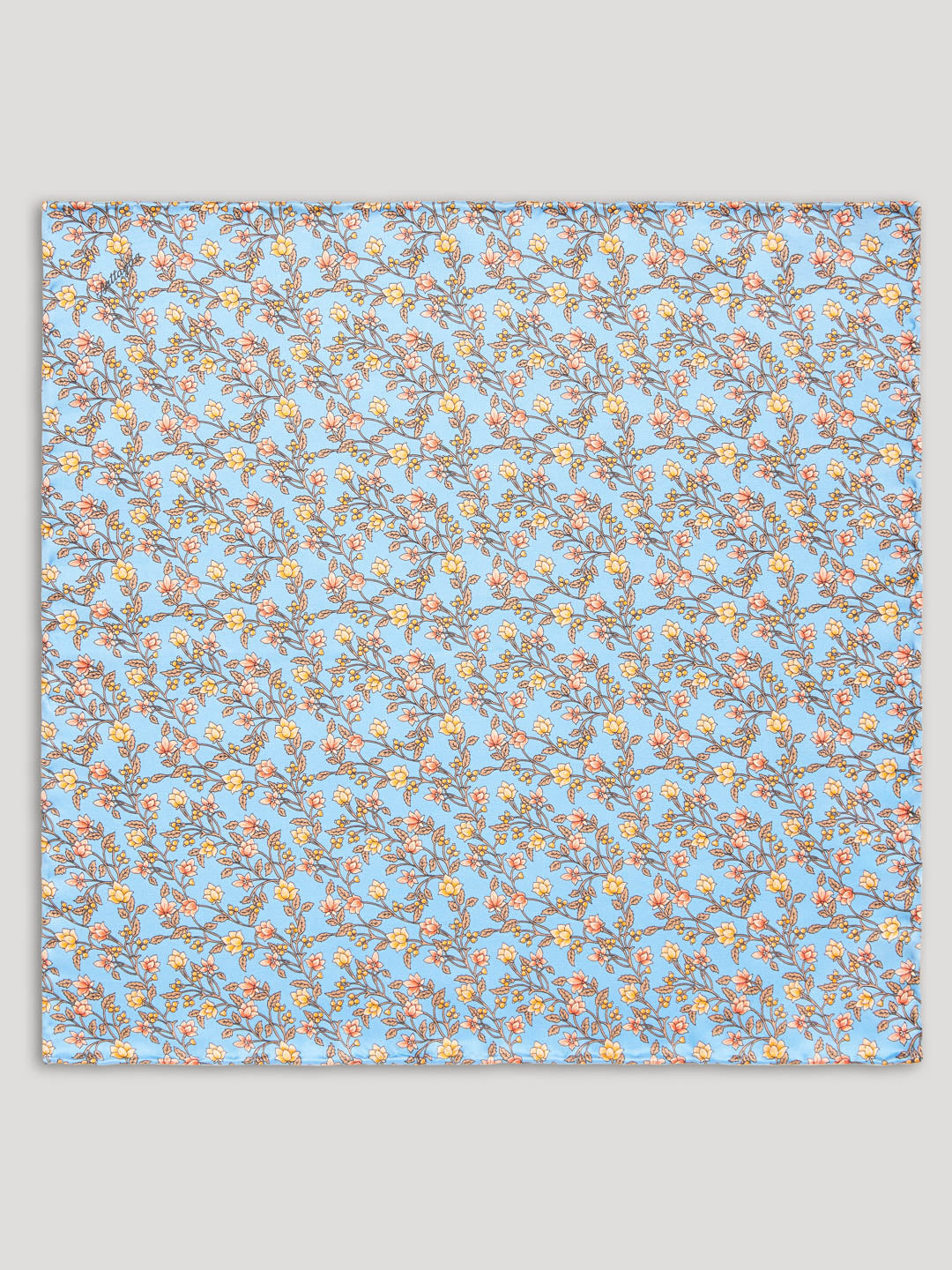Light blue handkerchief with yellow and orange floral details. 
