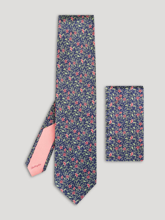 Navy tie with green and pink flowers and matching handkerchief.