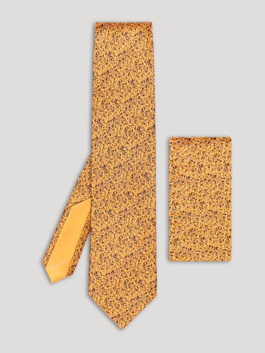 Golden yellow tie with black floral details and matching handkerchief.