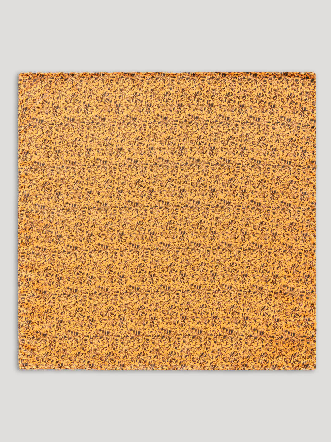 Golden yellow handkerchief with black floral details.