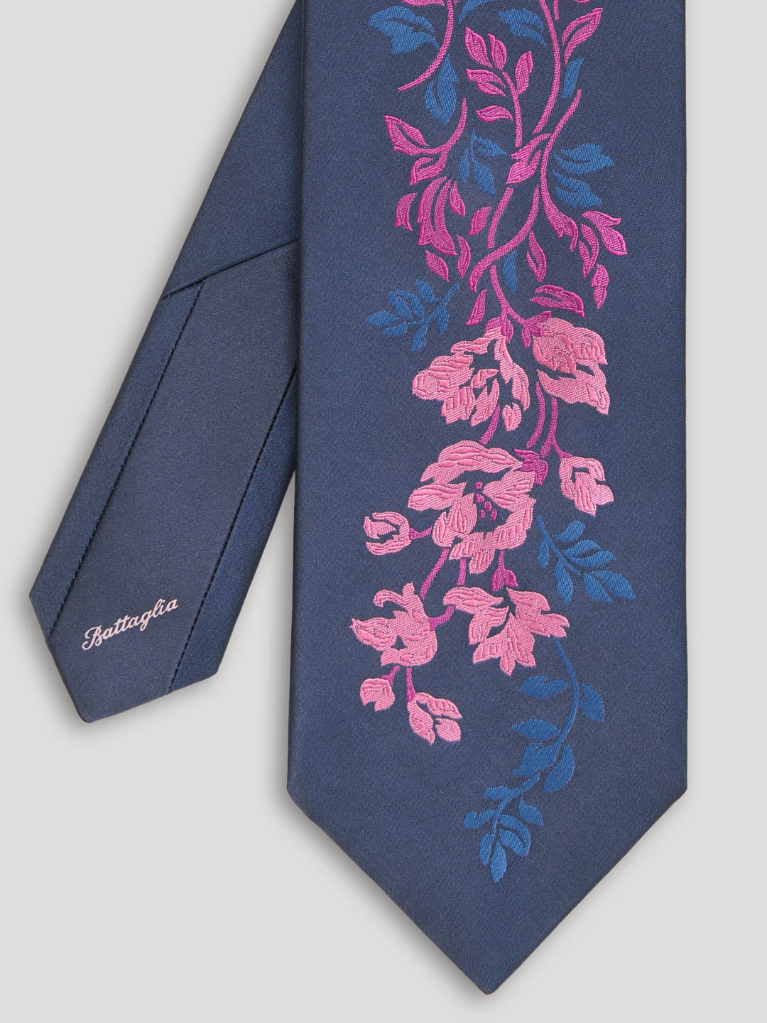 Navy tie with woven pink and blue floral design. 