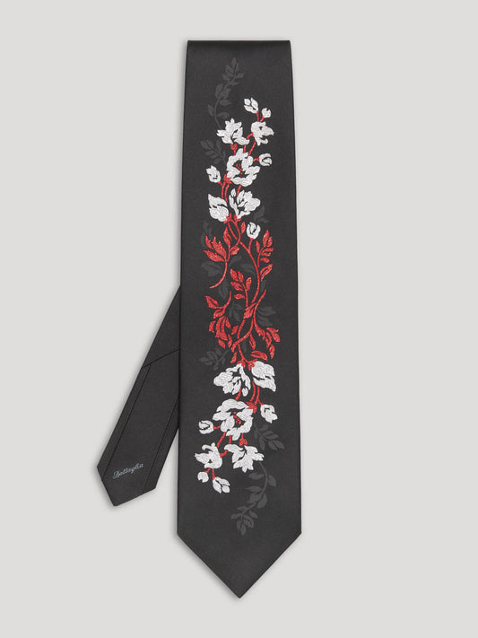 Black tie with silver and red woven floral details.