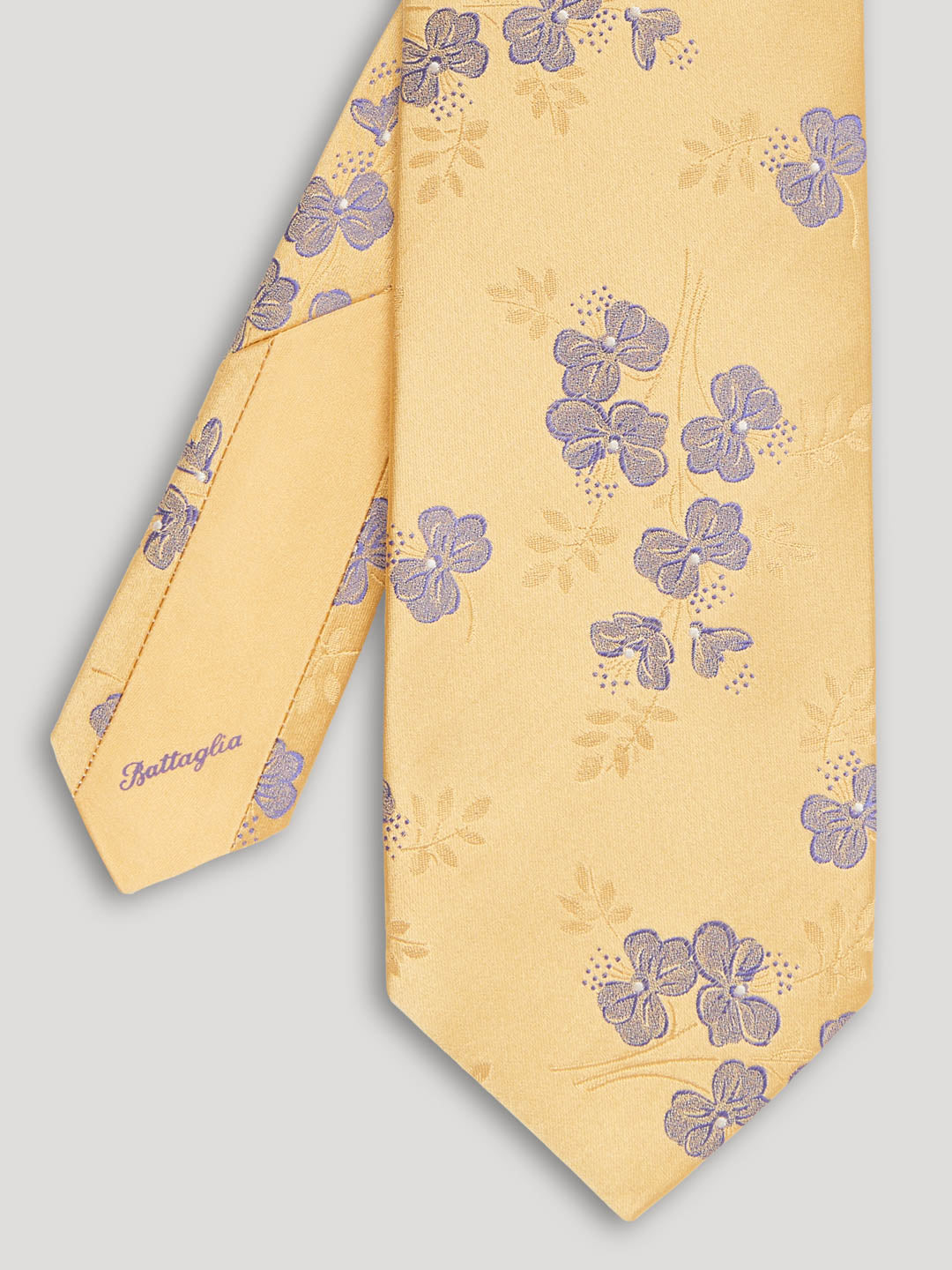 Yellow tie with purple flowers.