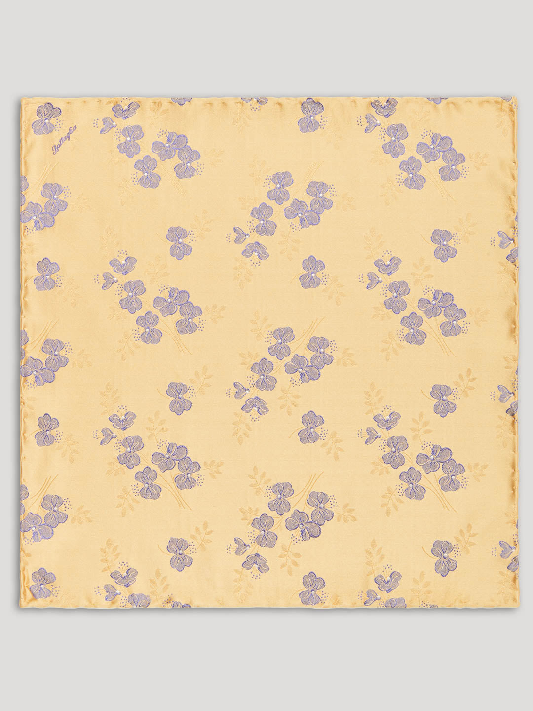 Yellow handkerchief with purple flowers on it. 