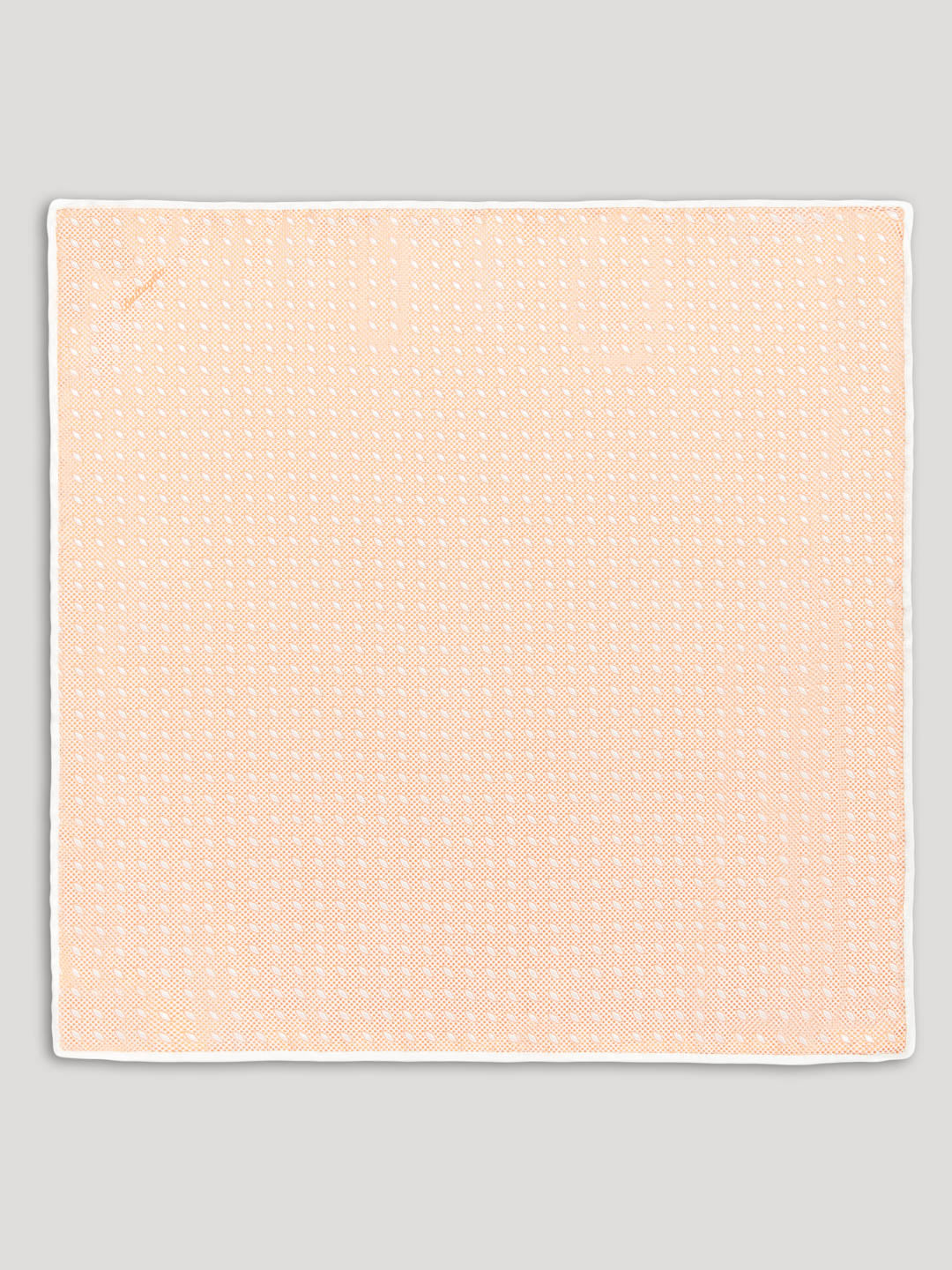 Peach handkerchief with white diamond details.