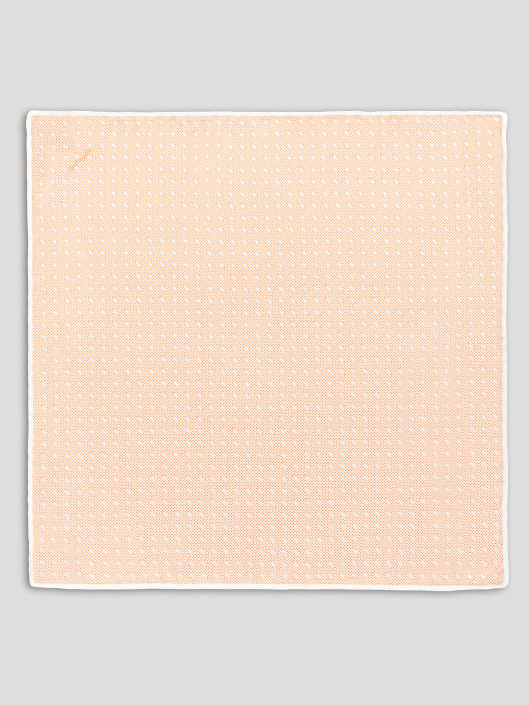 Peach handkerchief with white diamond details. 