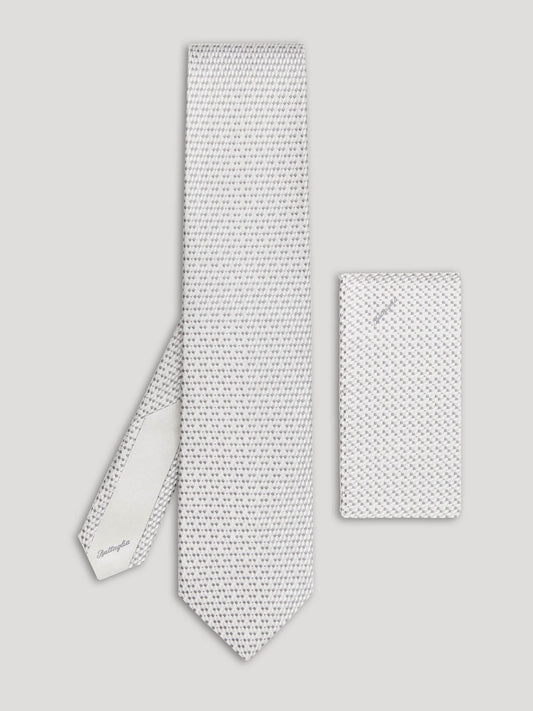 Silver tie with small grey geometric details and matching handkerchief.