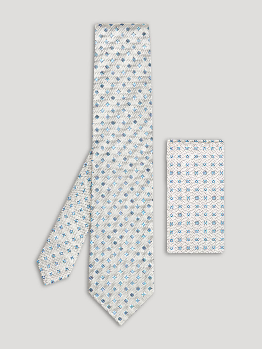 Silver tie with blue diamonds and matching handkerchief.