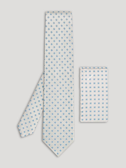 Silver tie with blue diamonds and matching handkerchief.