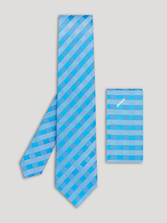 Blue geometric design tie with matching handkerchief.