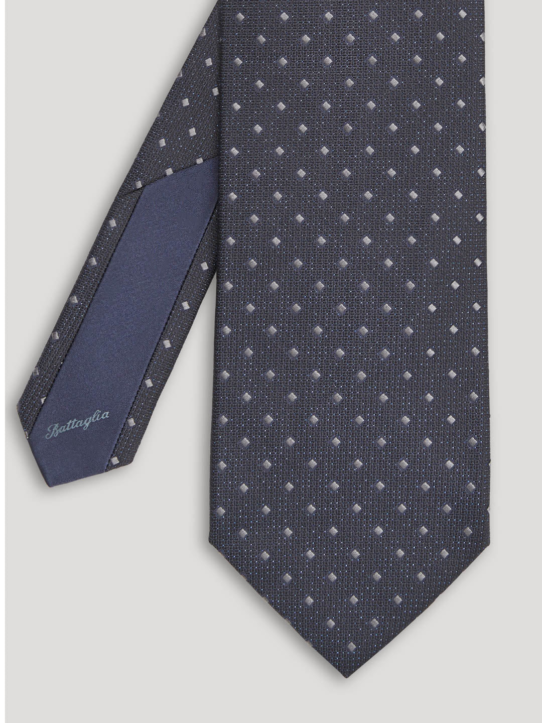 Black tie with small grey diamond design. 