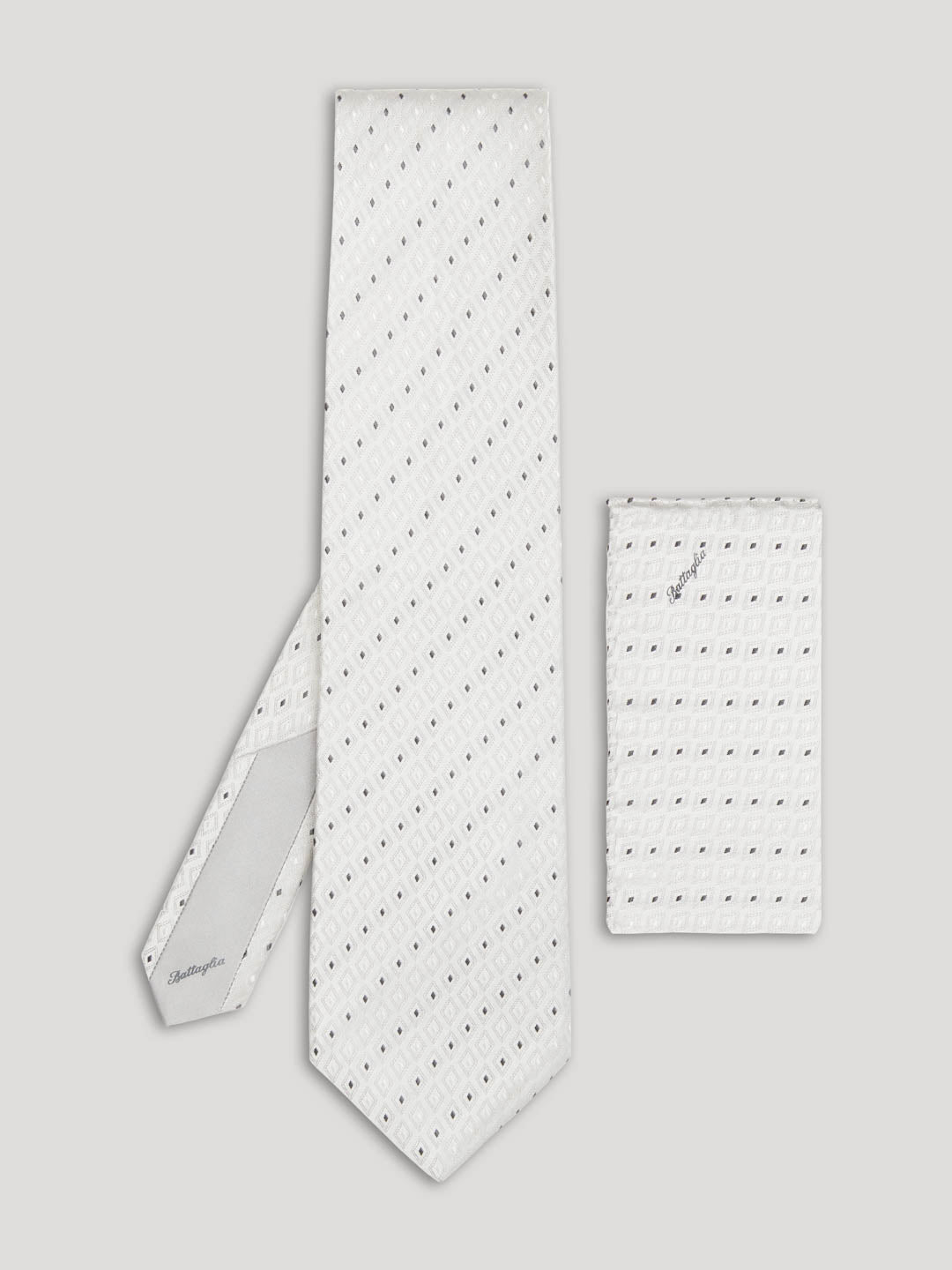 Silver tie with pinpoint geometric design and matching handkerchief.