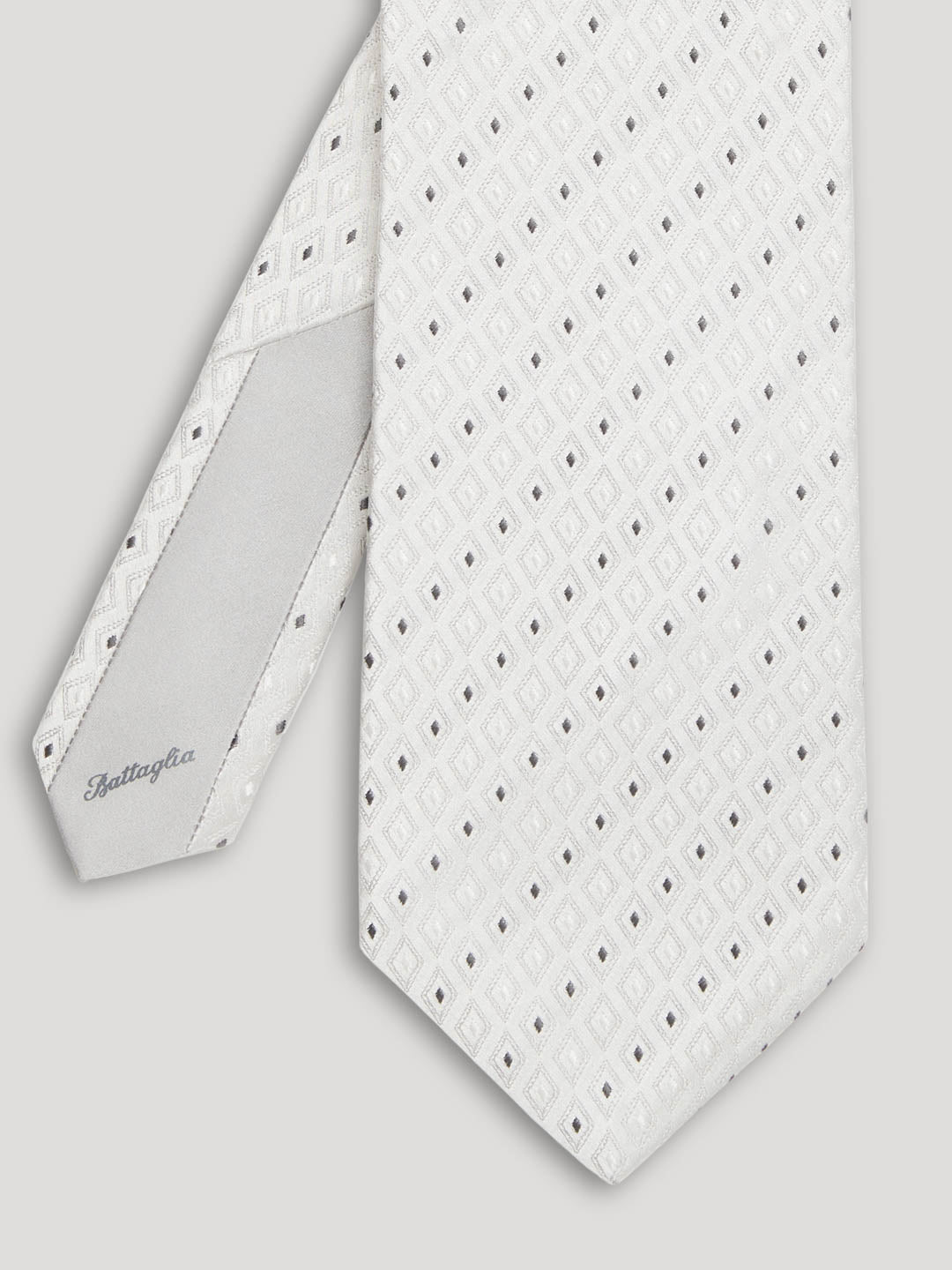 Silver tie with pinpoint geometric design.