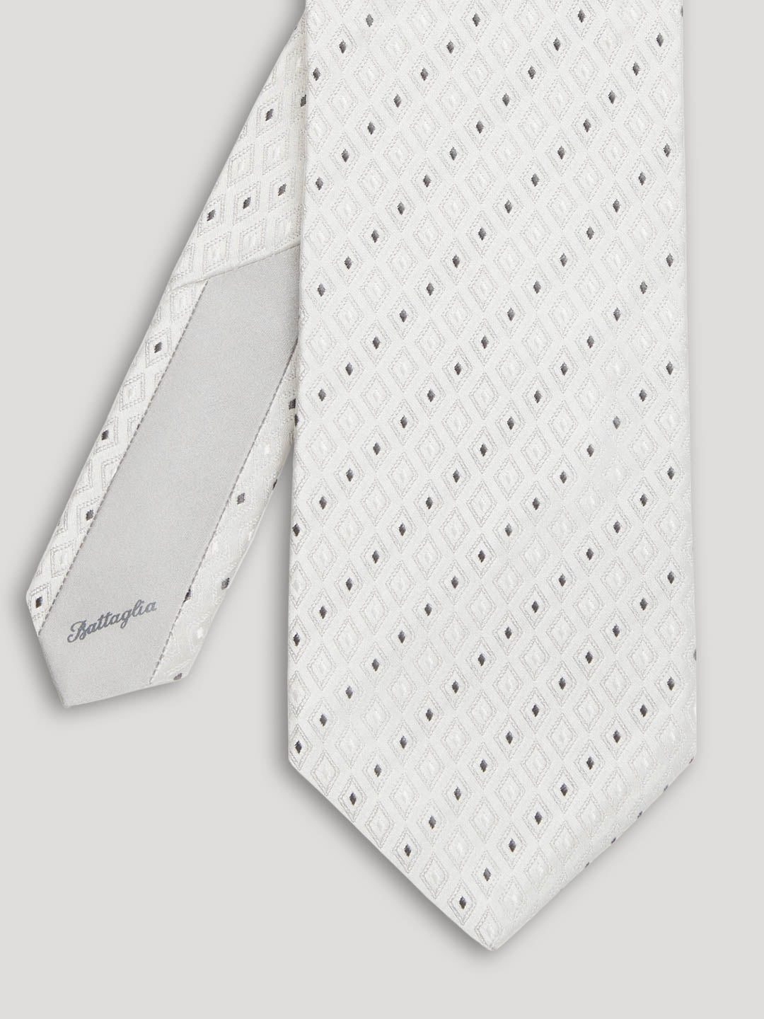Silver tie with pinpoint geometric design. 