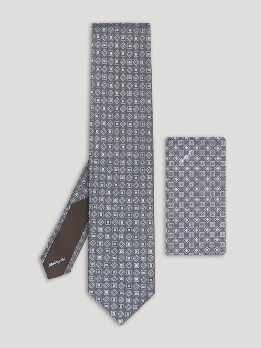 Grey tie with diamond and square design and matching handkerchief.
