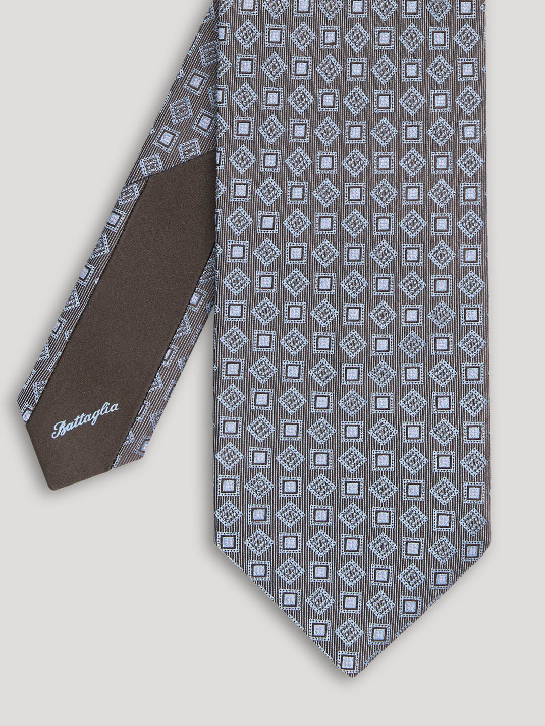 Grey tie with diamond and square design.