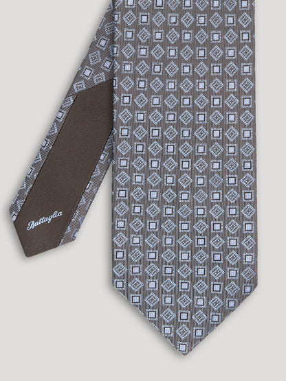 Grey tie with diamond and square design. 