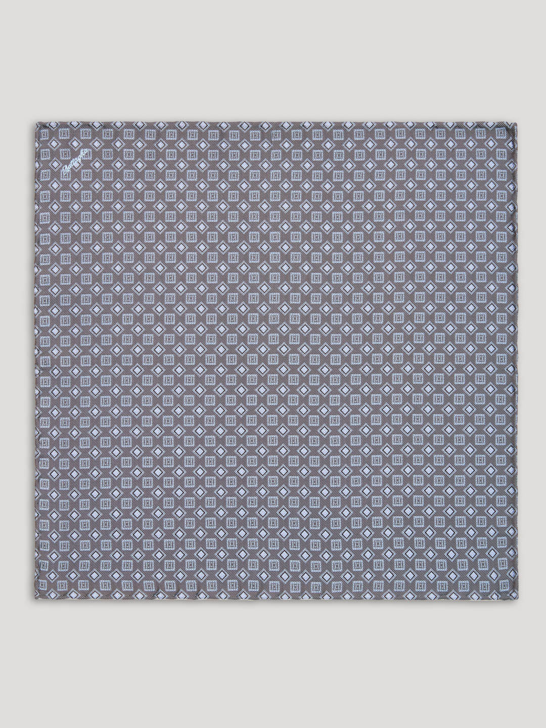 Grey handkerchief with square and diamond design.