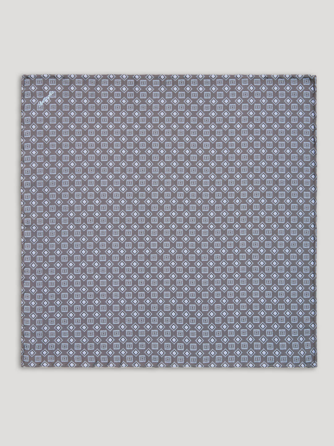 Grey handkerchief with square and diamond design. 