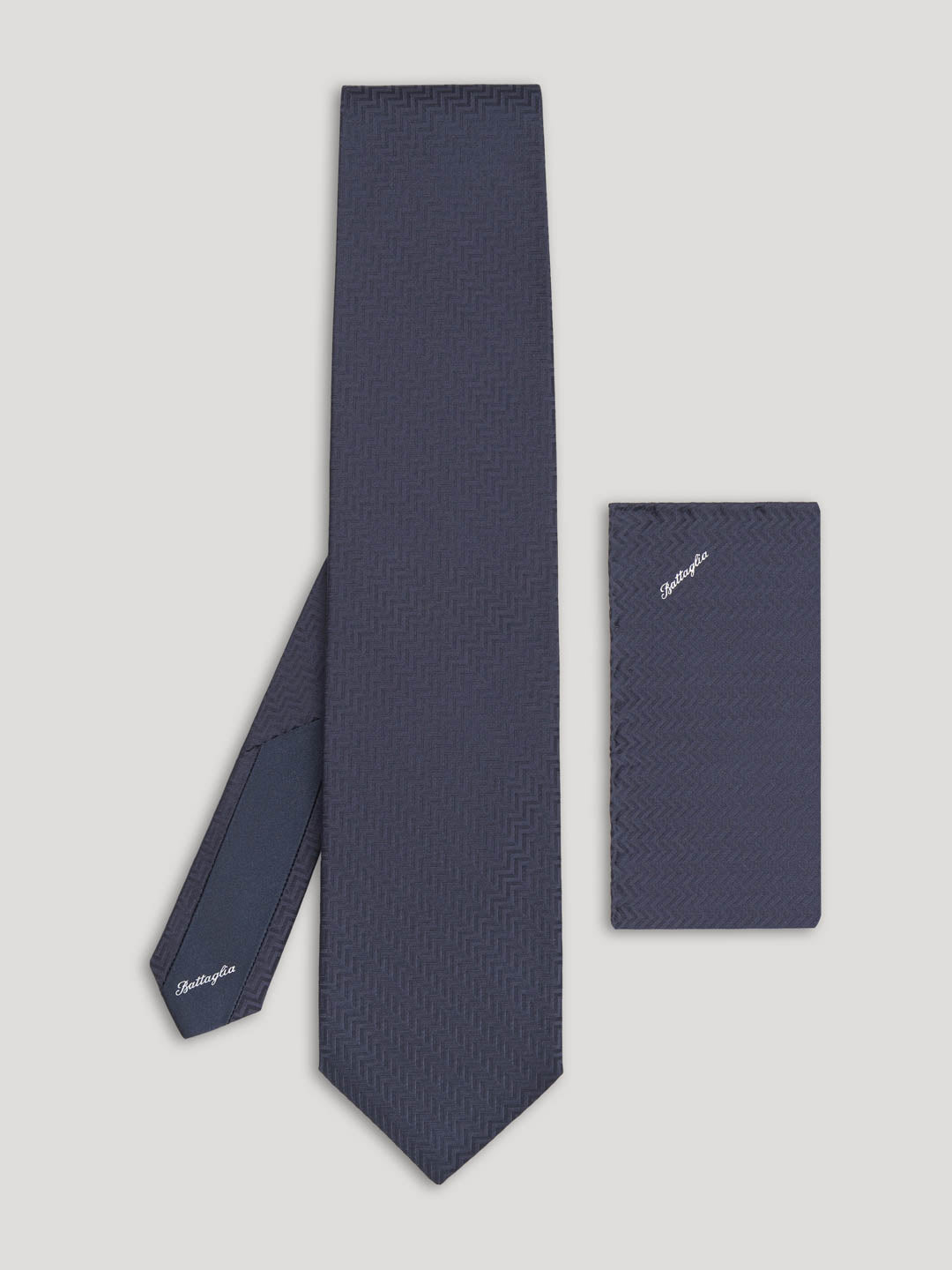 Black tone on tone zig zag design tie with matching handkerchief.