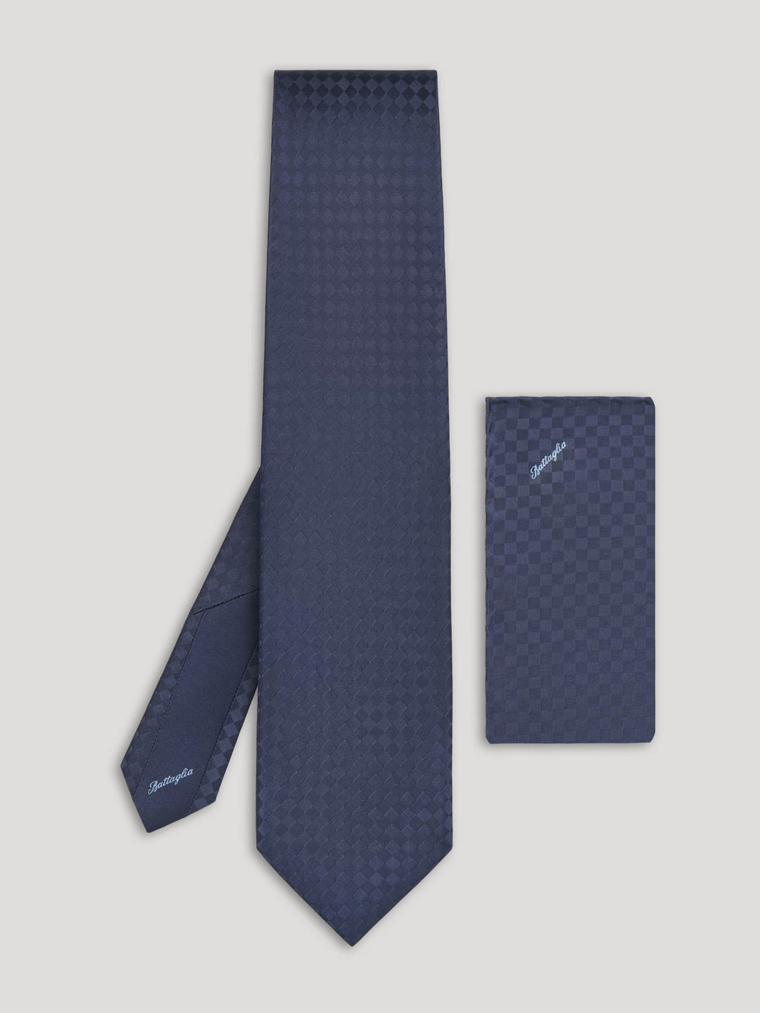 Blue tone on tone checkerboard tie with matching handkerchief.