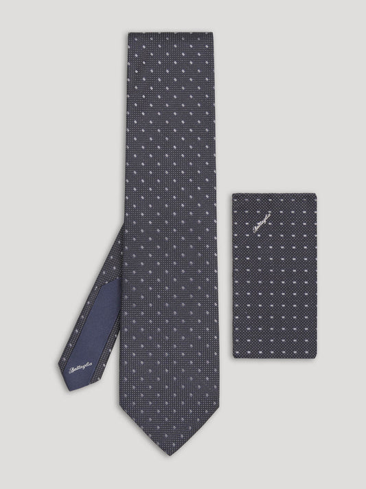 Black tie with silver geometric design and matching handkerchief.