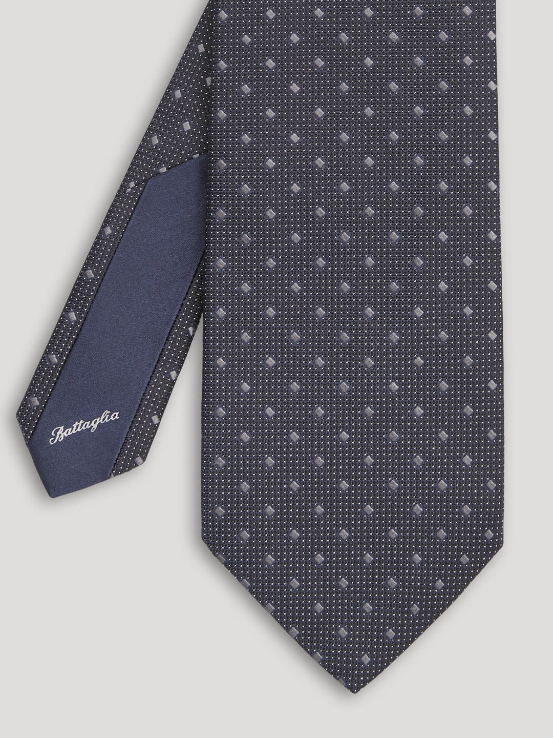 Black tie with silver geometric design.