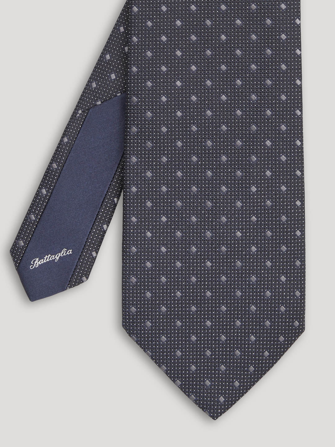 Black tie with silver geometric design. 
