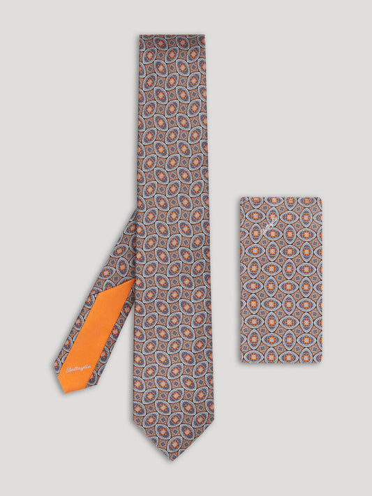 Orange and blue silk tie with large pattern and matching handkerchief.