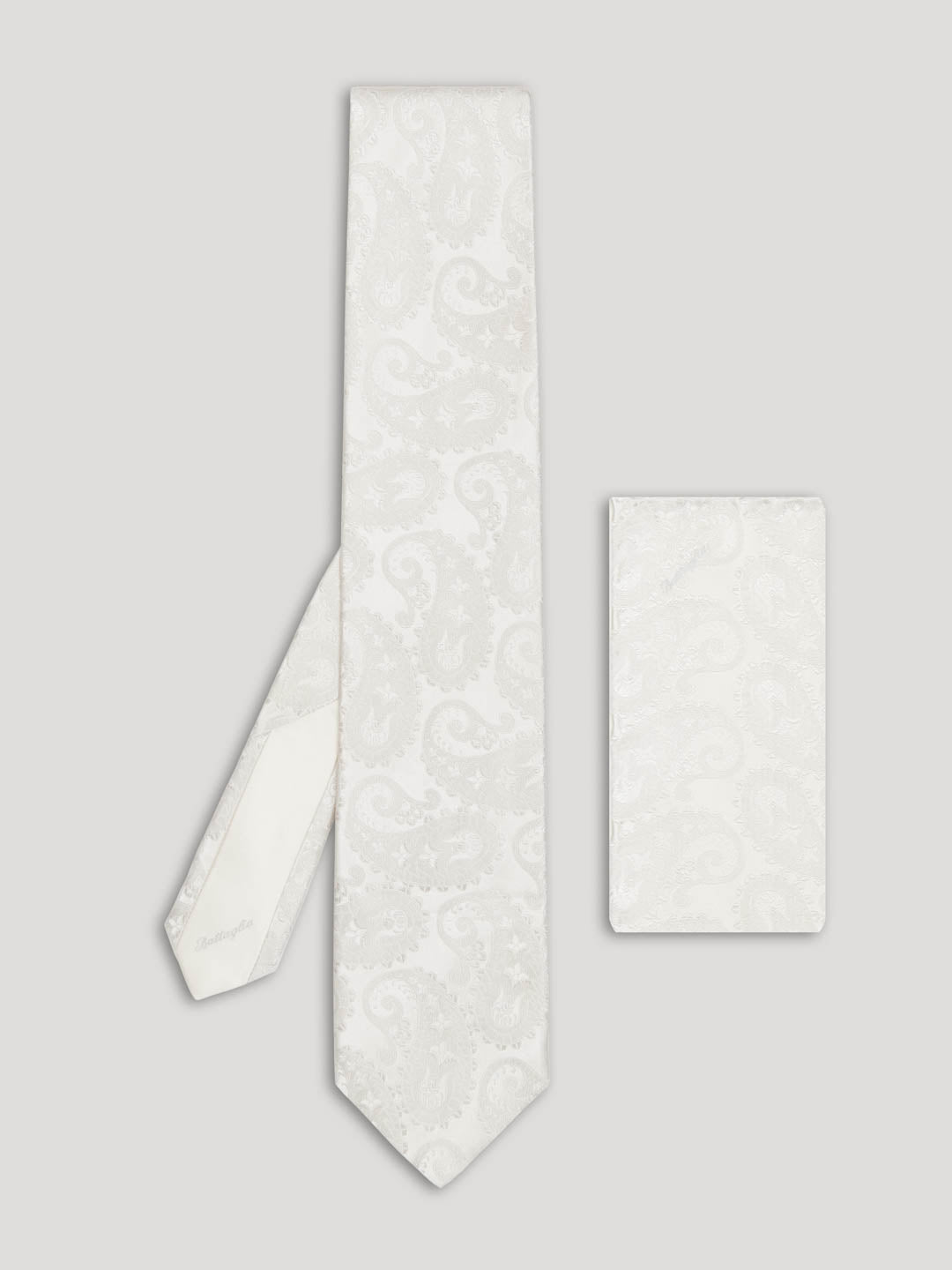White paisley silk tie with matching handkerchief.