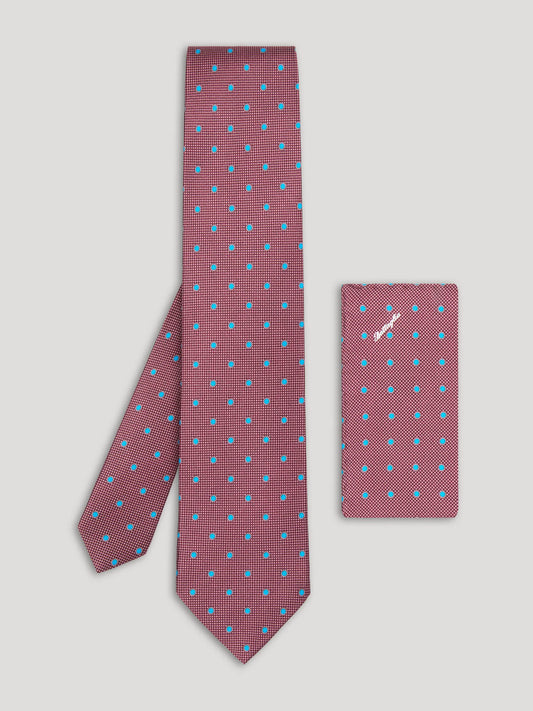 Purple tie with blue polkadots and matching handkerchief. 