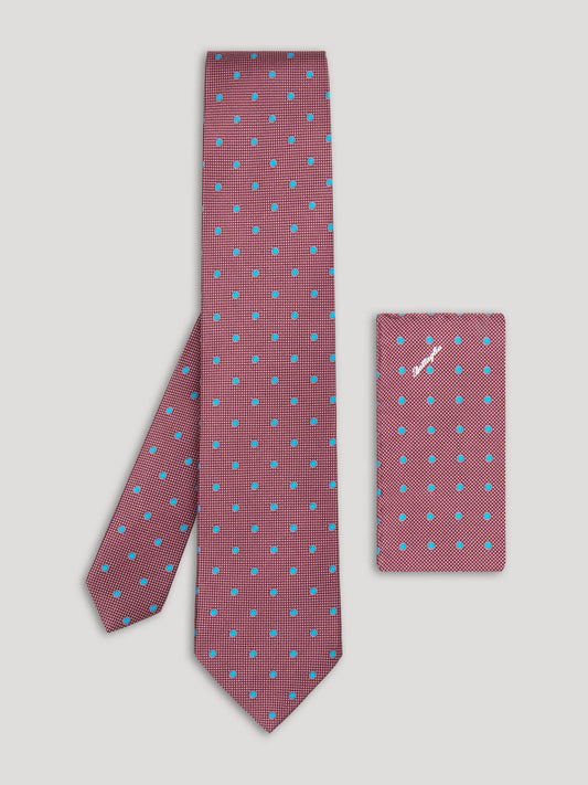 Purple tie with blue polkadots and matching handkerchief.