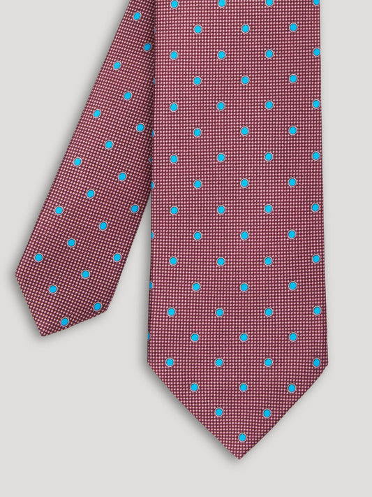 Purple tie with blue polkadots.