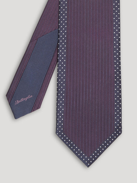 Deep purple tie with small white polkadots.