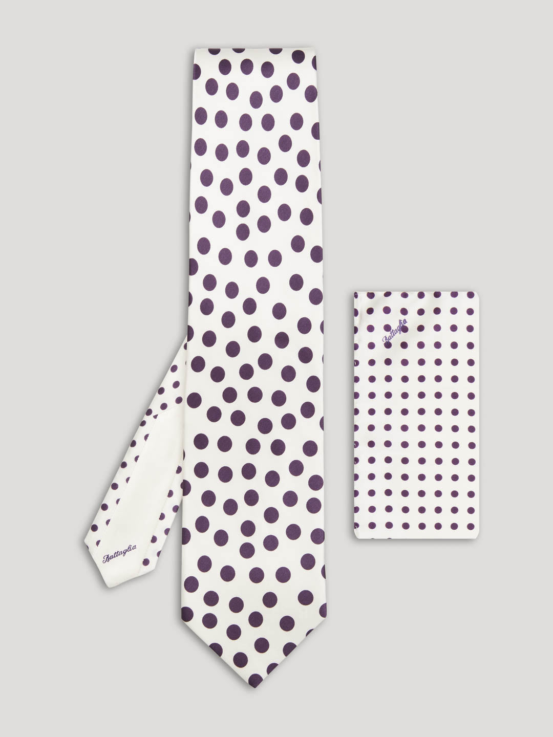 White tie with large purple polkadots and matching handkerchief. 