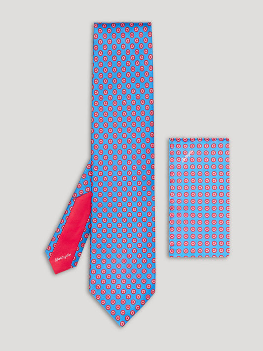 Blue tie with red polkadots and matching handkerchief.