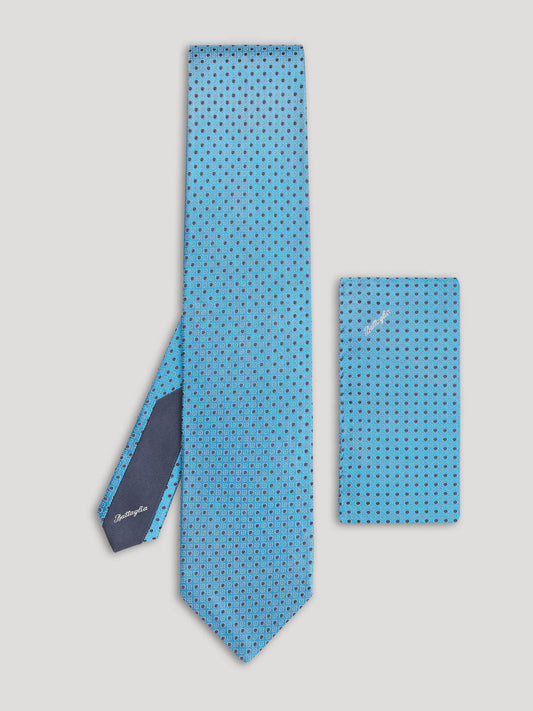 Blue tie with navy polkadots and matching handkerchief.